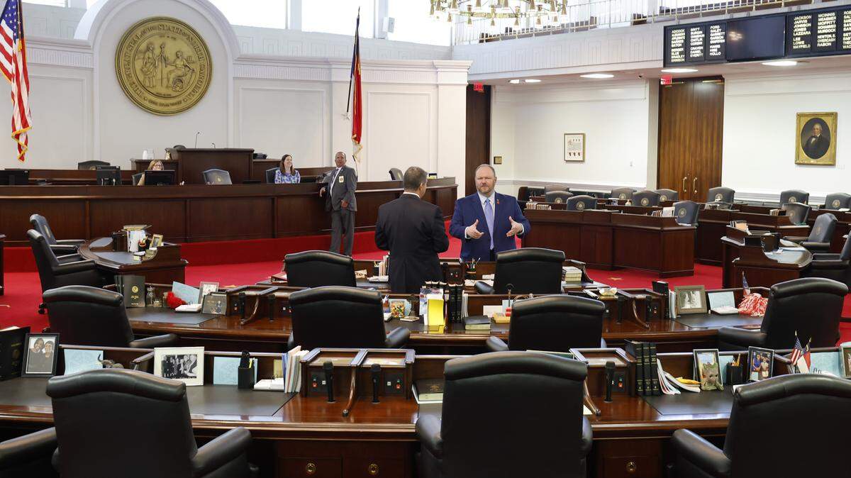 N.C. Sen. Ralph Hise, right, talks with N.C. Sen. Warren Daniel before session in the N.C. Senate chamber in the Legislative Building in Raleigh, Tuesday, April 21, 2026.