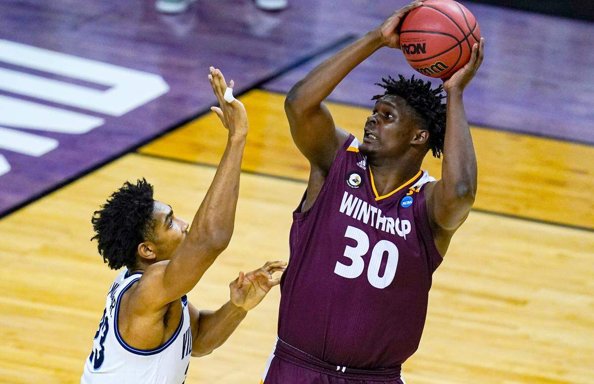 Winthrop forward D.J. Burns Jr. (30) shoots over Villanova forward Jermaine Samuels (23) in the first half of a first round game in the NCAA men’s college basketball tournament at Farmers Coliseum in Indianapolis, Friday, March 19, 2021.