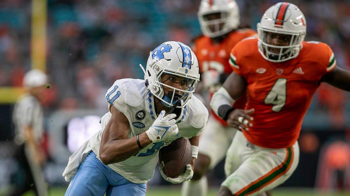North Carolina wide receiver Josh Downs (11) scores on a 15-yard pass from quarterback Drake Maye (10) to give the Tar Heels’ a 21-7 lead in the second quarter against Miami on Saturday, October 8, 2022 at Hard Rock Stadium in Miami Gardens, Florida.