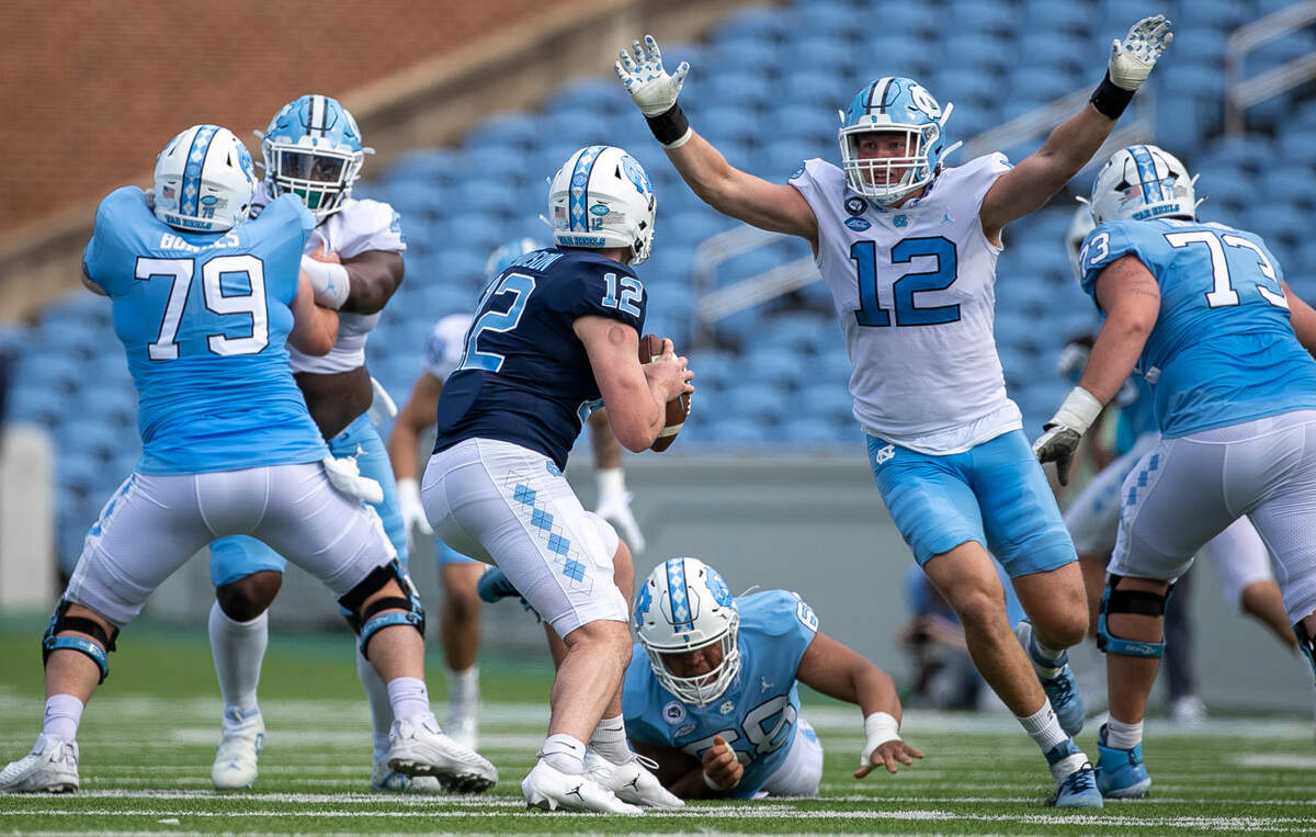 North Carolina defensive lineman Beau Atkinson (12) pressures quarterback Tad Hudson (12) during the Tar Heels’ spring football game on Saturday, April 15, 2023 at Kenan Stadium in Chapel Hill, N.C.