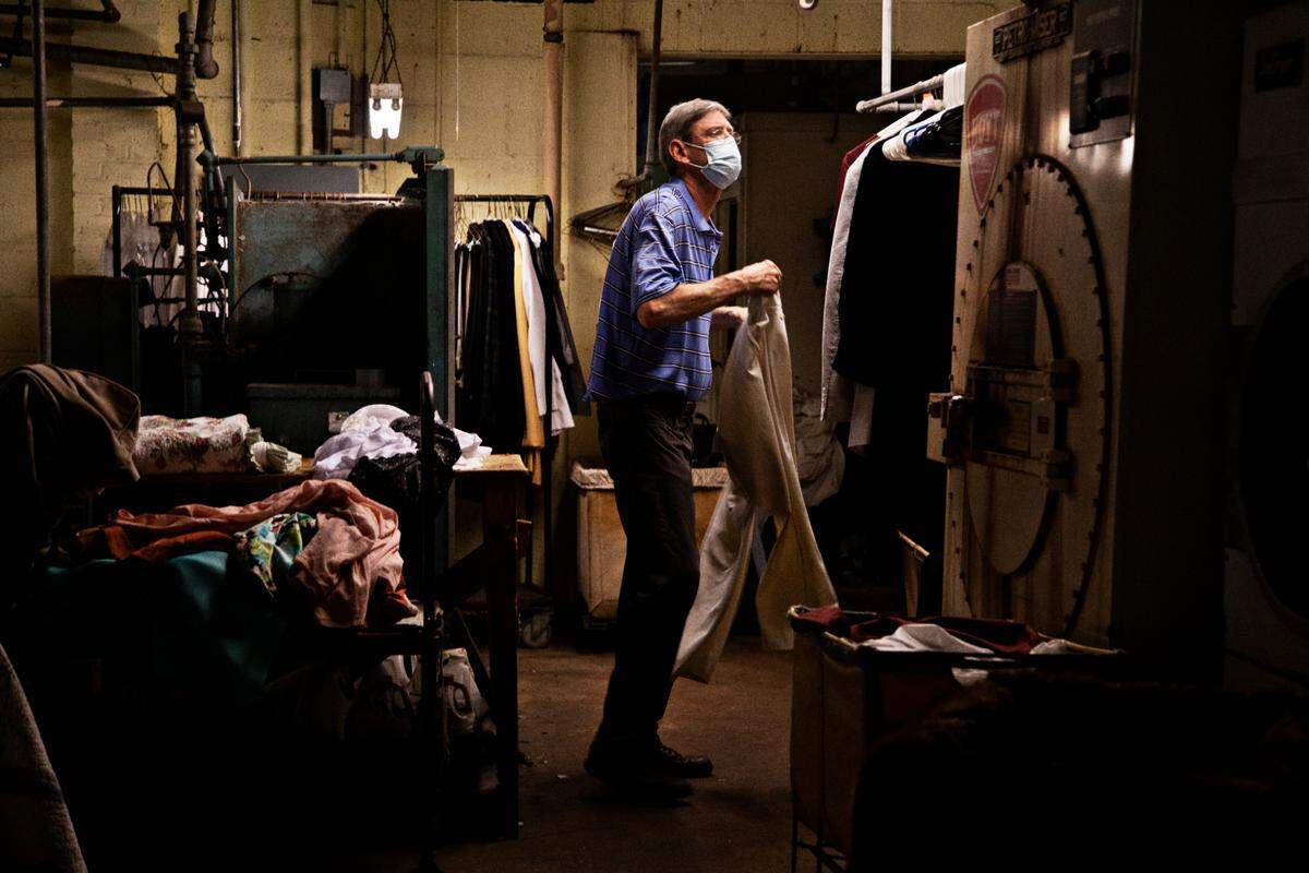 Tim Honeycutt, who started working at the family business at age 20, prepares a customer’s items for cleaning at Honeycutt Cleaners in Raleigh on Wednesday, May 5, 2021. The business, which got its start around 1946, will be closing for good May 14th due to challenges from the pandemic, increases in costs and a drop in business.