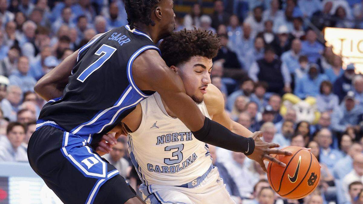 Duke’s Dame Sarr (7) defends North Carolina's Derek Dixon (3) during the first half of Duke’s game against UNC at the Dean E. Smith Center in Chapel Hill, N.C., Saturday, Feb. 7, 2026.