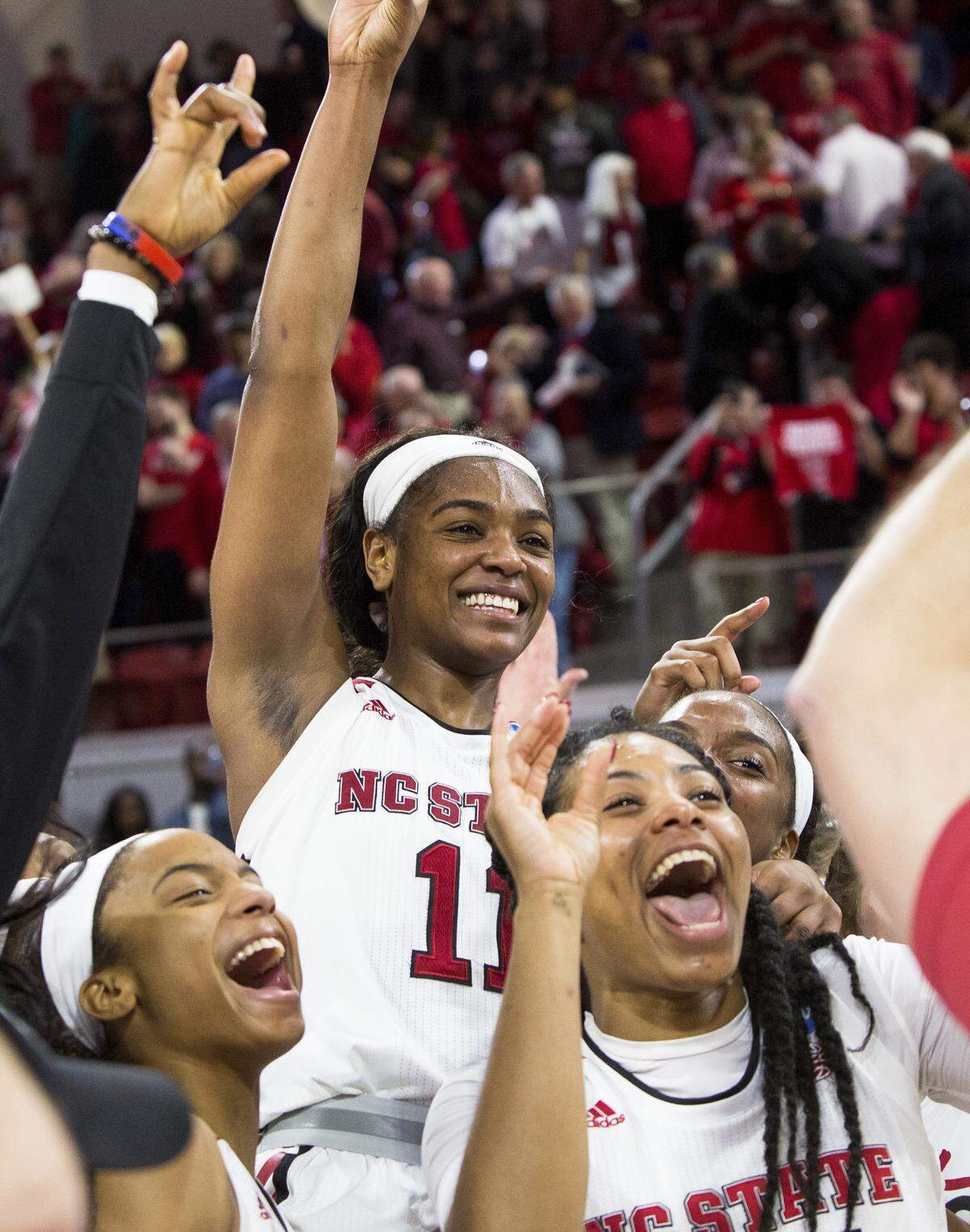 North Carolina State's Kiara Leslie (11) celebrates with her teammates following a victory in a second-round game in the NCAA women's college basketball tournament against Maryland in Raleigh, N.C., Sunday, March 18, 2018. North Carolina State defeated Maryland 74-60.