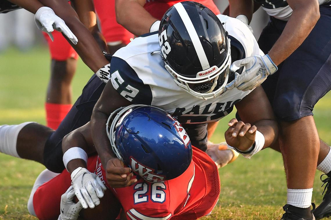 Southeast Raleigh’s Chase Robinson (52) tackles Wake Forest’s Mehki Carr (26) during the first half. The Southeast Raleigh Bulldogs and the Wake Forest Cougars met in a non-conference game in Wake Forest, N.C. on September 1, 2023.
