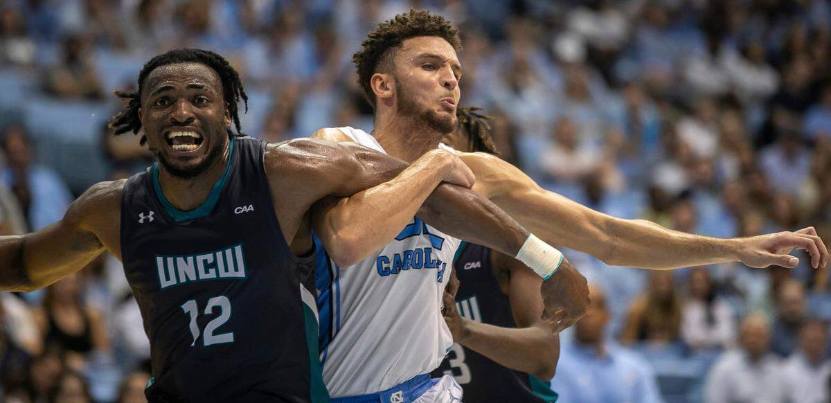 North Carolina’s Pete Nance (32) battles with UNC Wilmington’s Victor Enoh (12) for a rebound following a free throw in the second half on Monday, November 7, 2022 at the Smith Center in Chapel Hill, N.C.