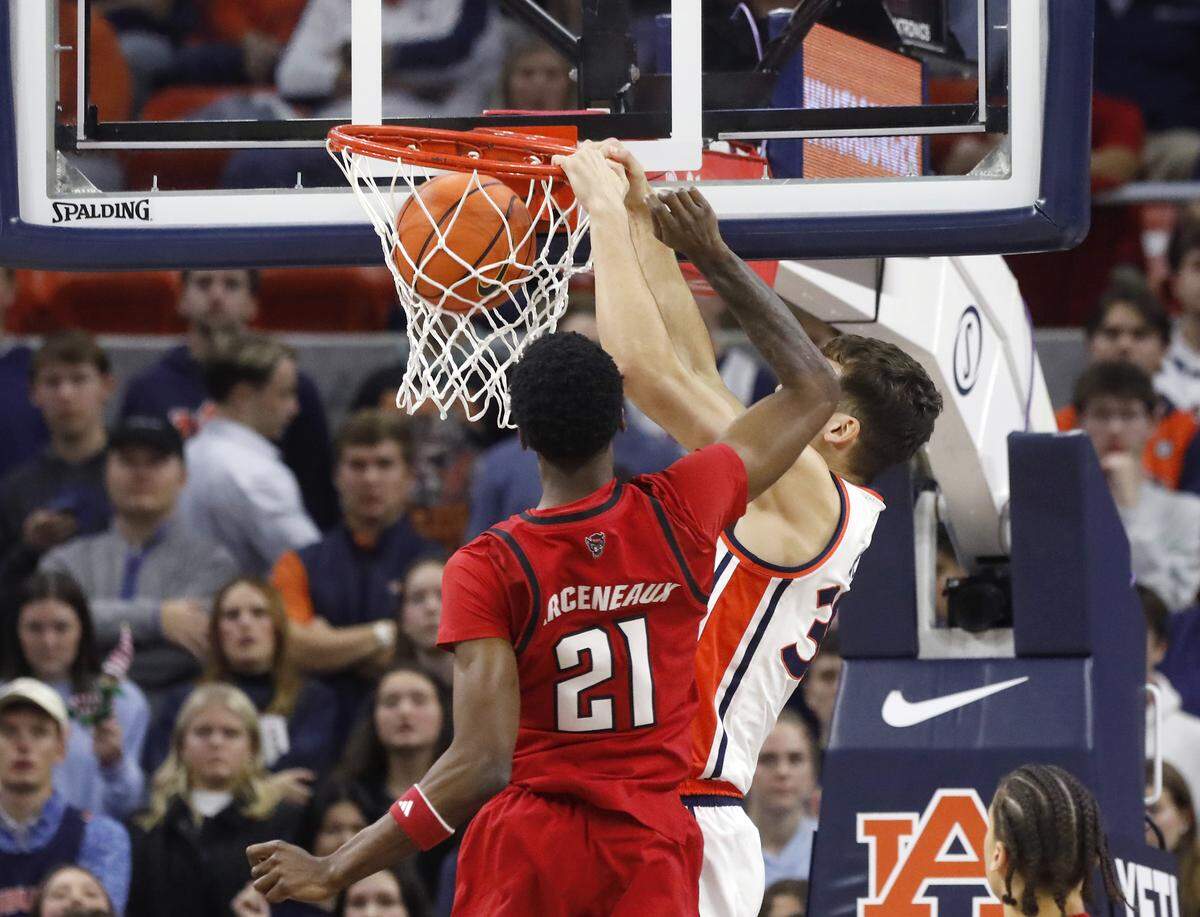 Auburn’s Filip Jovic gets past N.C. State’s Terrance Arceneaux for a dunk during the first half of the Wolfpack’s 83-73 loss in the ACC/SEC Challenge on Wednesday, Dec. 3, 2025, at Neville Arena in Auburn, Ala. 