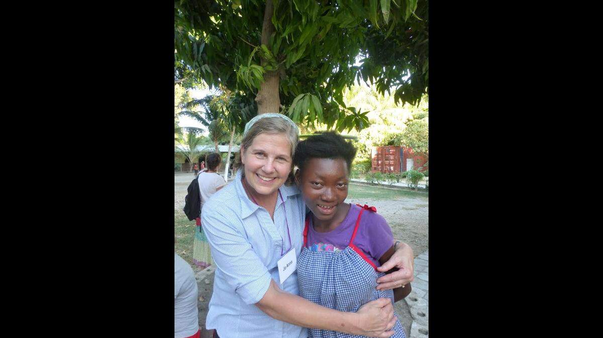 Jo Anna McMillan with Leonise, who lives in a girls' home in Haiti sponsored by the Raleigh group Hearts & Hands for Haiti.