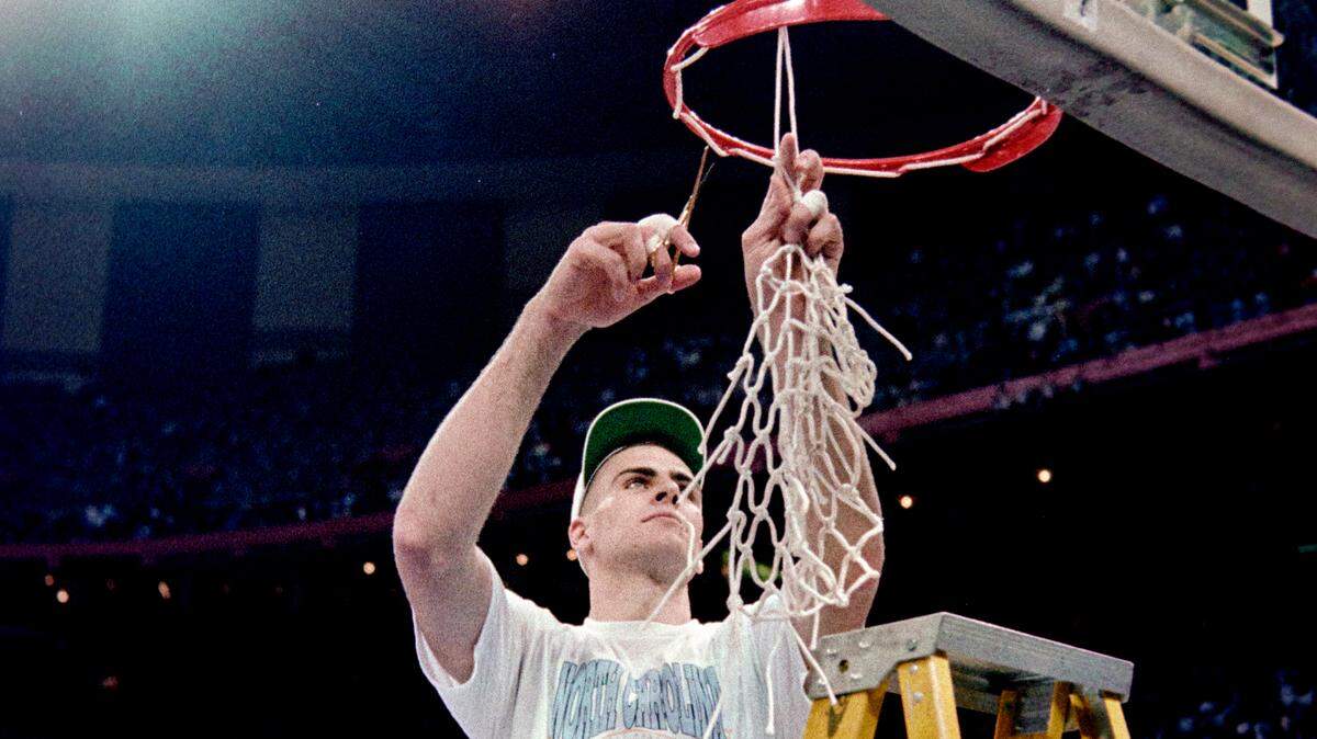 UNC center Eric Montross cuts down a portion of the nets after the Tar Heels defeated Michigan to win the NCAA championship game in New Orleans in 1993.