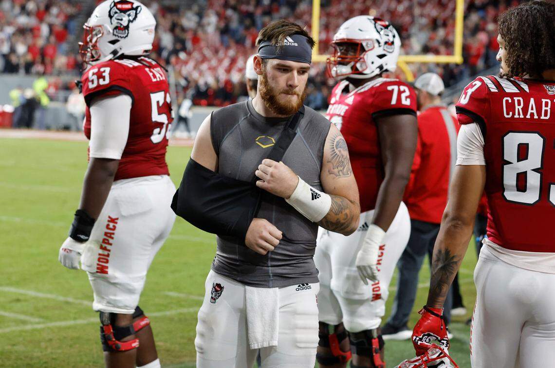 N.C. State quarterback Devin Leary (13) watches from the sidelines during the second half of N.C. State’s 19-17 victory over Florida State at Carter-Finley Stadium in Raleigh, N.C., Saturday, Oct. 8, 2022.