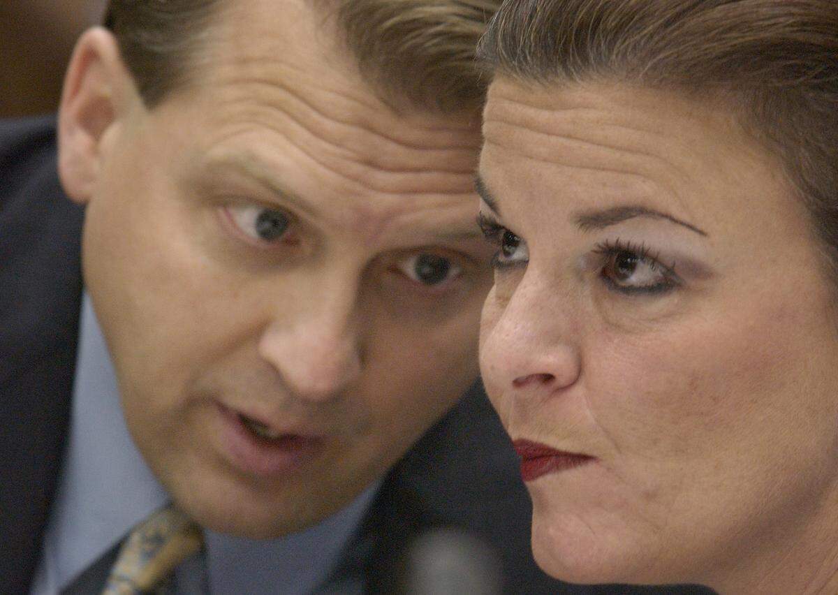 A 2003 photo shows Durham District Attorney Jim Hardin (left) speaking with assistant DA Freda Black as she prepares to question self described male escort Brent Wolgamott, 28, of Raleigh in the Michael Peterson murder trial Monday.