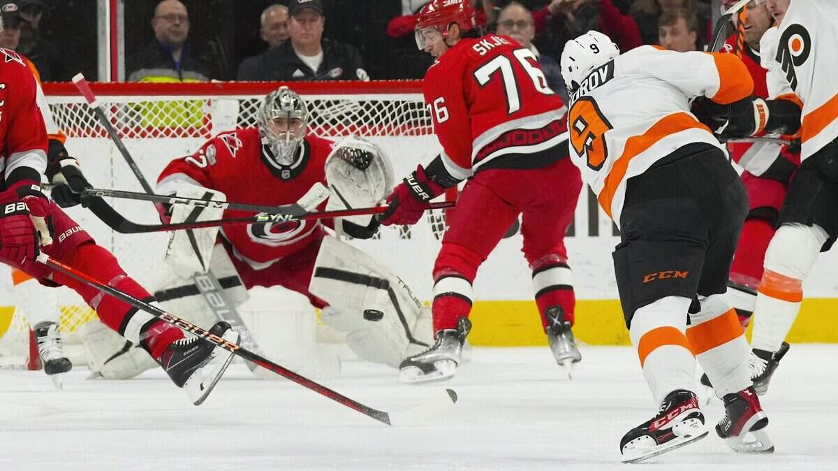 Philadelphia Flyers defenseman Ivan Provorov (9) takes a shot towards Carolina Hurricanes goaltender Pyotr Kochetkov (52) during the first period at PNC Arena.