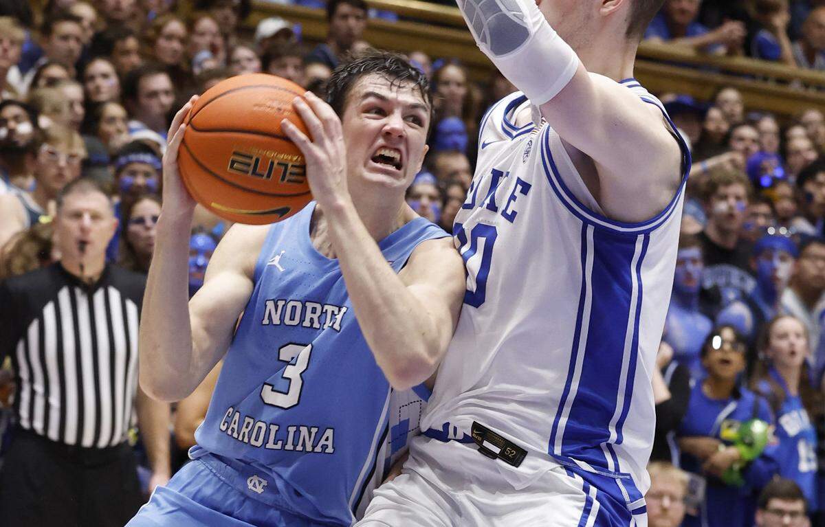 North Carolina’s Cormac Ryan (3) heads to the basket as Duke’s Kyle Filipowski (30) defends during the first half of Duke’s game against UNC at Cameron Indoor Stadium in Durham, N.C., Saturday, March 9, 2024.