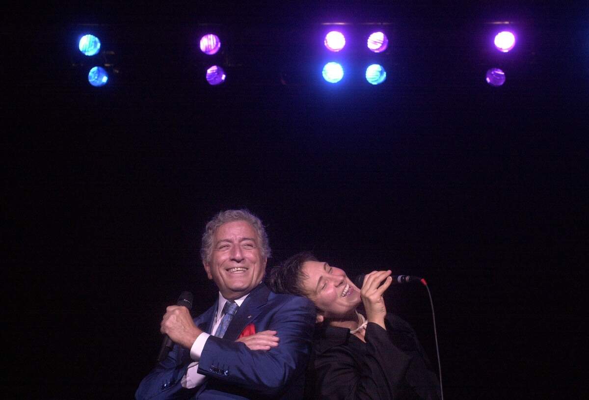 Tony Bennett and k.d. lang sing a duet during their concert at Raleigh’s Walnut Creek Pavillion Aug. 5, 2001.