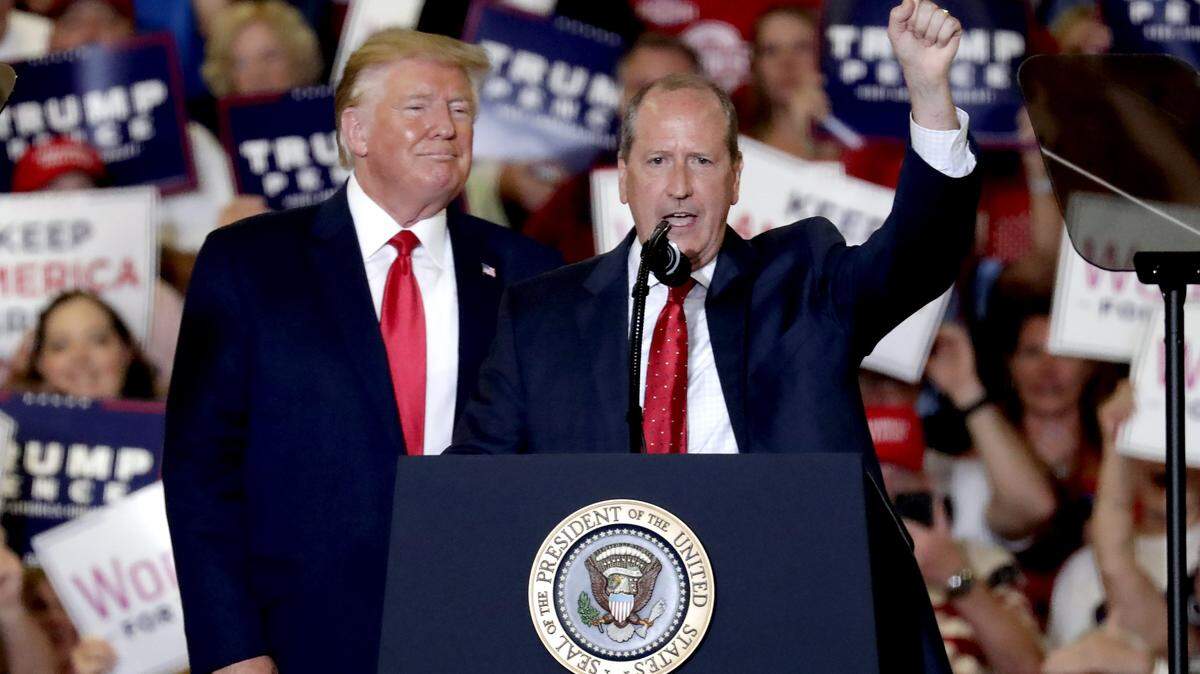 President Donald Trump, left, gives his support to Dan Bishop, right, a Republican running for the special North Carolina 9th District U.S. Congressional race as he speaks at a rally in Fayetteville, N.C., Monday, Sept. 9, 2019.