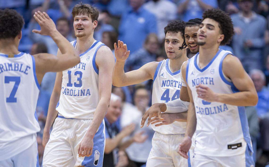 North Carolina guard Luka Bogavac (44) is surrounded by teammates after sinking a key three-point basket to give the Tar Heels a 59-53 lead in the second half against Clemson on Tuesday, March 3, 2026 at the Smith Center in Chapel Hill, N.C. Bogavac lead the Tar Heels with 20 points in their 67-63 victory.