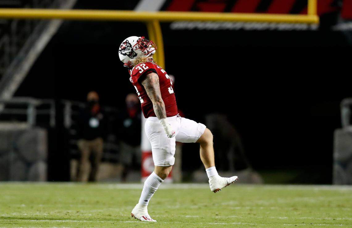 N.C. State linebacker Drake Thomas (32) celebrates after sacking Wake Forest quarterback Sam Hartman (10) during the first half of N.C. State’s game against Wake Forest at Carter-Finley Stadium in Raleigh, N.C, Saturday, Sept. 19, 2020.
