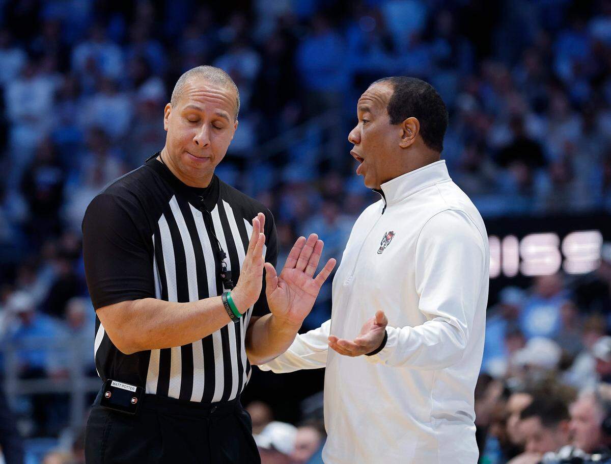 N.C. State head coach Kevin Keatts speaks with an official during the first half of the Wolfpack’s 97-73 loss to North Carolina on Wednesday, Feb. 19, 2025, at the Smith Center in Chapel Hill, N.C. 