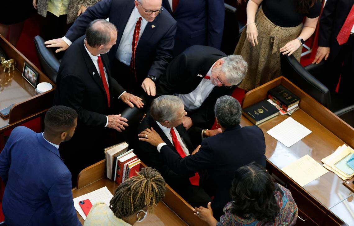 People attend to Rep. William Brisson after he passed out during the opening session of the N.C. House of Representatives Wednesday, Jan. 11, 2023.