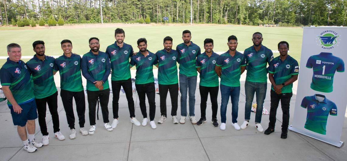 Morrisville Mayor TJ Cawley (left) and members of the new Morrisville Raptors cricket team pose for a photo during the Raptors’ launch event at Church Street Park on Tuesday, June 21, 2022.