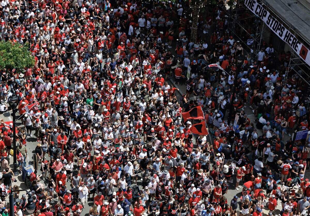 Thousands of Carolina Hurricanes fans walk along Fayetteville Street following a parade honoring the team’s Stanley Cup Championship on Saturday, June 20, 2026, in Raleigh, N.C.
