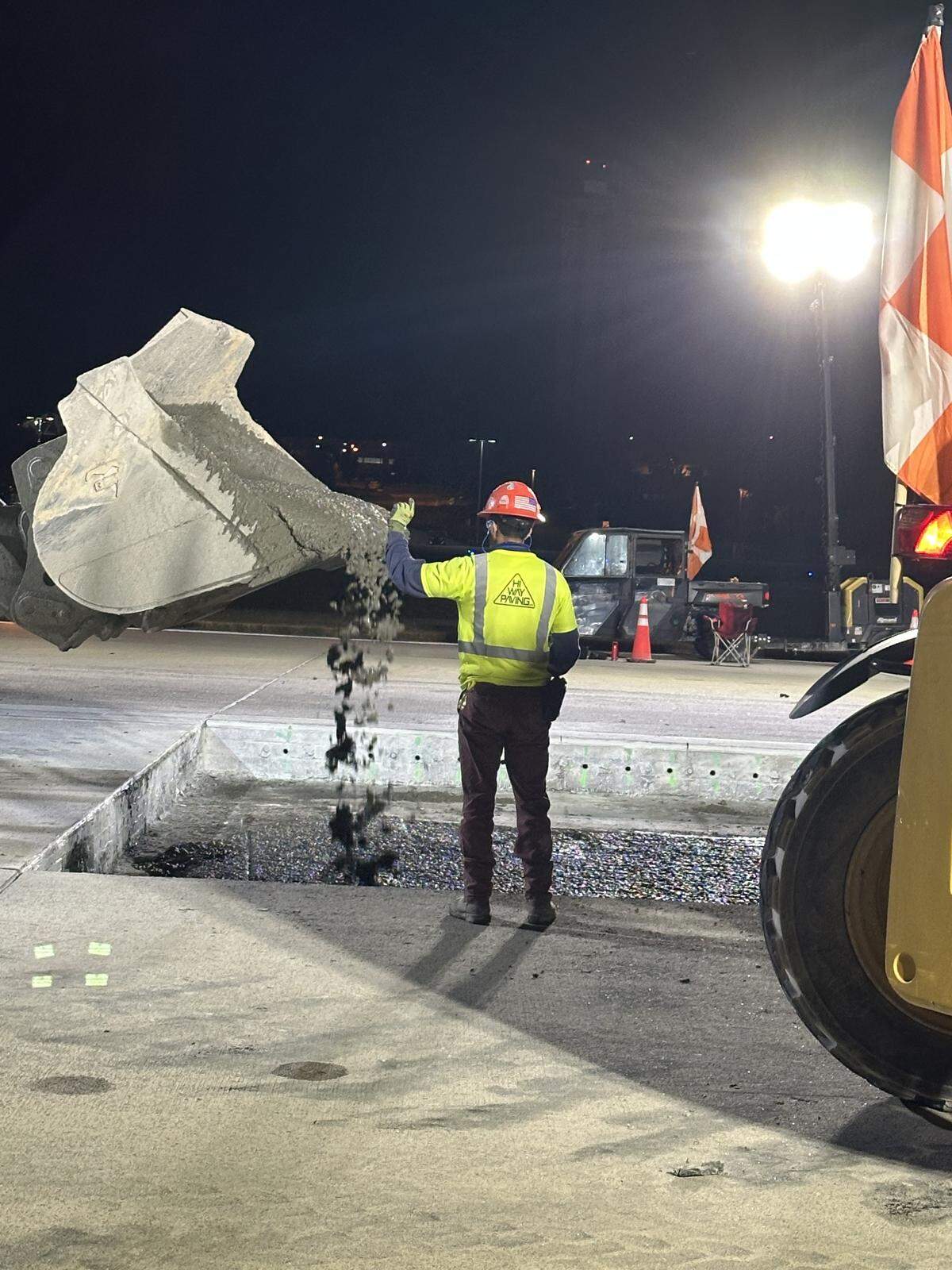 The first wet concrete is poured from a front-end loader into the 25-by-50-foot hole in the main runway at Raleigh-Durham International Airport on Oct. 20, 2025.