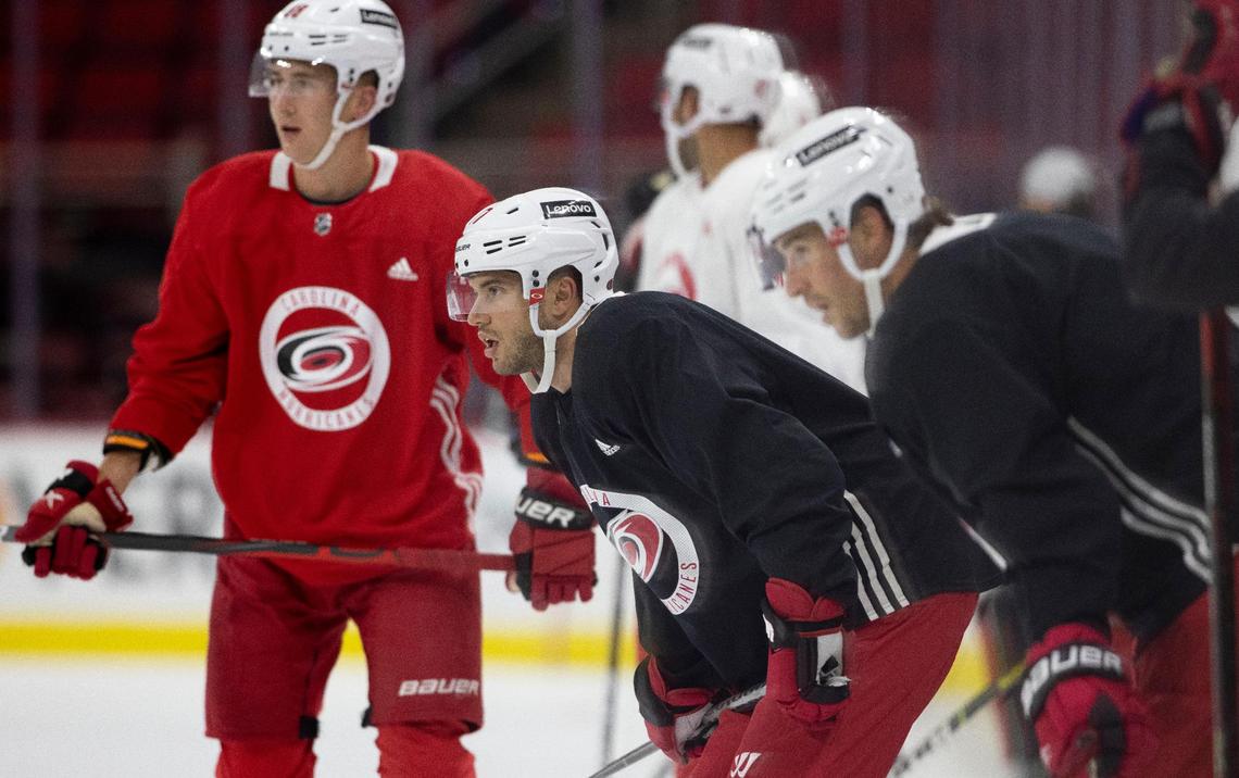 Carolina Hurricanes’ Tony DeAngelo (77) listens to coach Rod Brind’Amour during the opening day of training camp on Thursday, September 23, 2021 at PNC Arena in Raleigh, N.C.
