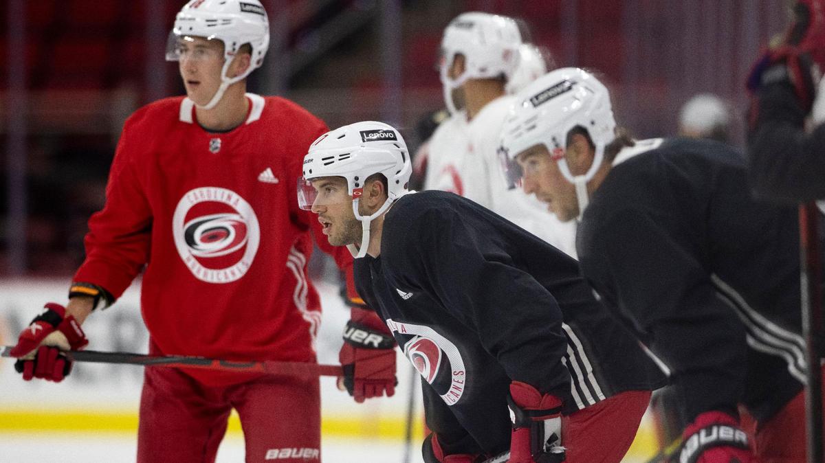 Carolina Hurricanes’ Tony DeAngelo (77) listens to coach Rod Brind’Amour during the opening day of training camp on Thursday, September 23, 2021 at PNC Arena in Raleigh, N.C.