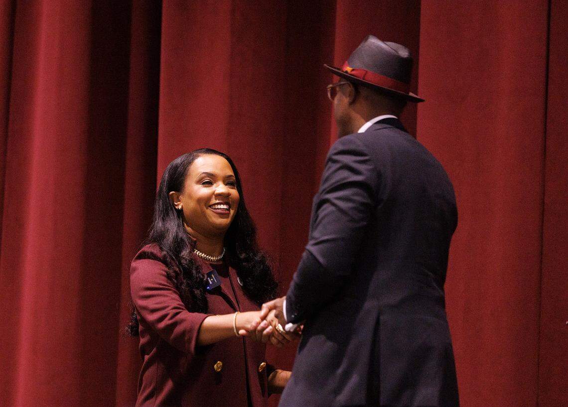 Karrie Dixon shakes hands with Stephen Fusi after being named the new chancellor of North Carolina Central University on Thursday, June 6, 2024, in Durham, N.C.