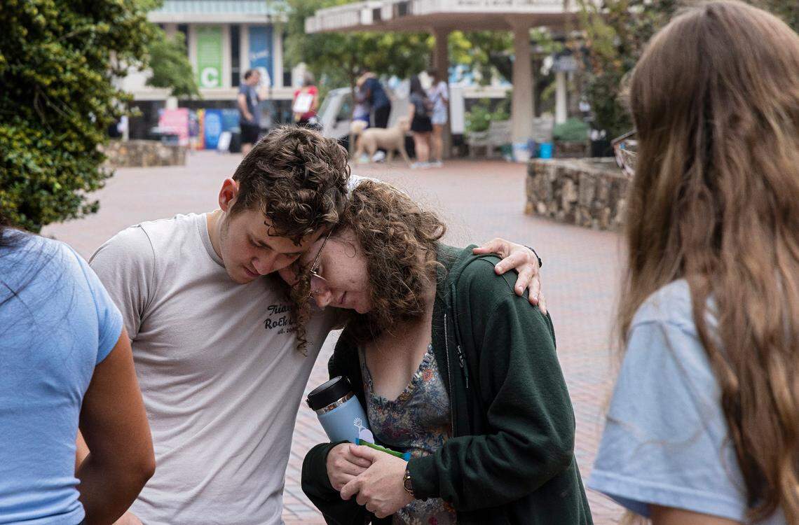 UNC-Chapel Hill first-year students Lucas Moore and Katie Fiore embrace on Tuesday, Aug. 29, 2023, in Chapel Hill, N.C. following a Monday shooting that left a faculty member dead on the university’s campus.