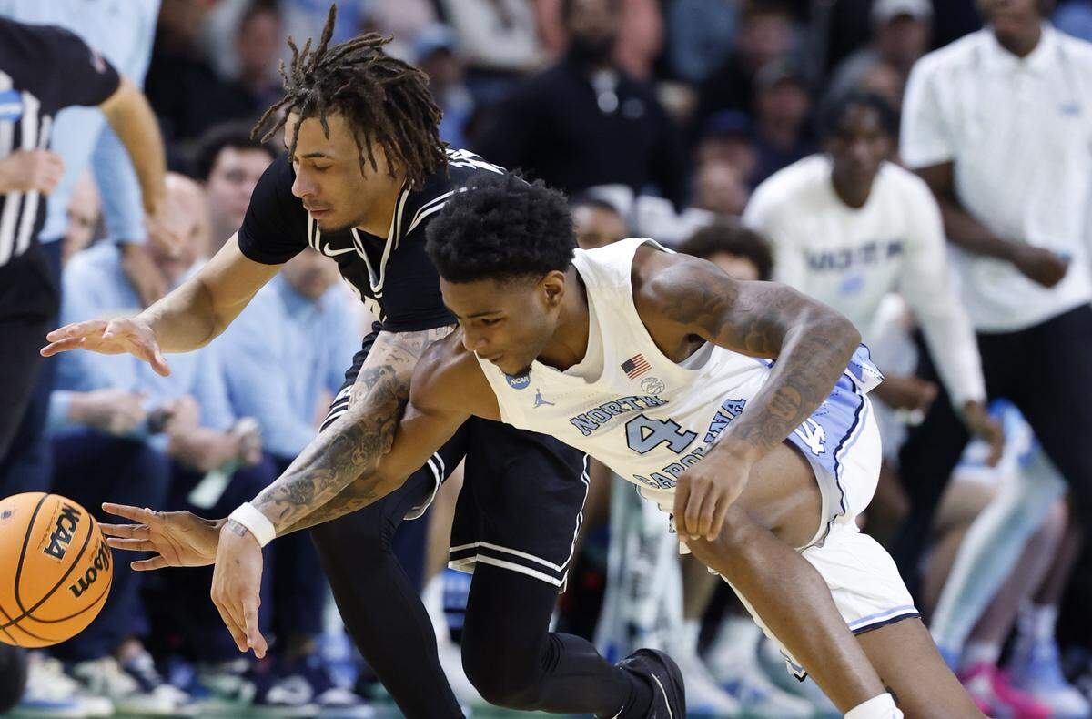North Carolina's Jaydon Young (4) tries to steal the ball from VCU’s Jadrian Tracey (2) during the first half of UNC’s game against VCU in the first round of the NCAA Men’s Basketball Tournament at  Bon Secours Wellness Arena in Greenville, S.C., Thursday, March 19, 2026.
