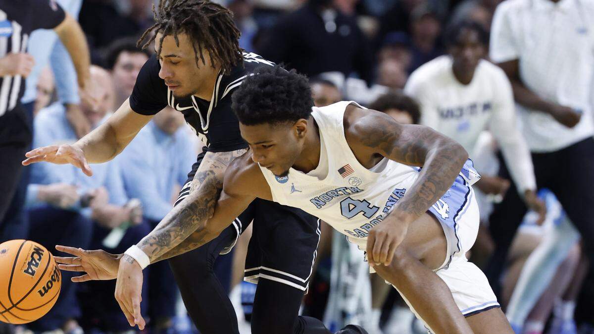 North Carolina's Jaydon Young (4) tries to steal the ball from VCU’s Jadrian Tracey (2) during the first half of UNC’s game against VCU in the first round of the NCAA Tournament on March 19, 2026, at Bon Secours Wellness Arena in Greenville, S.C.