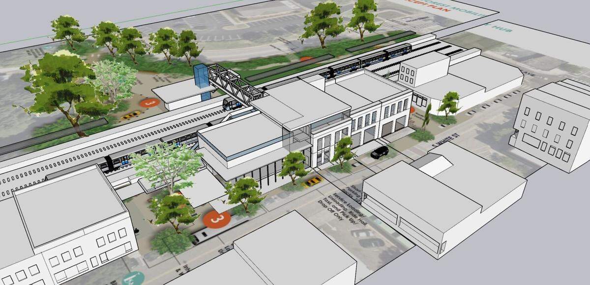 A rendering of another version of the proposed train station in downtown Wake Forest. White Street is in the foreground, with a pedestrian bridge over the tracks to a planned drop-off and pick-up area on East South Street.