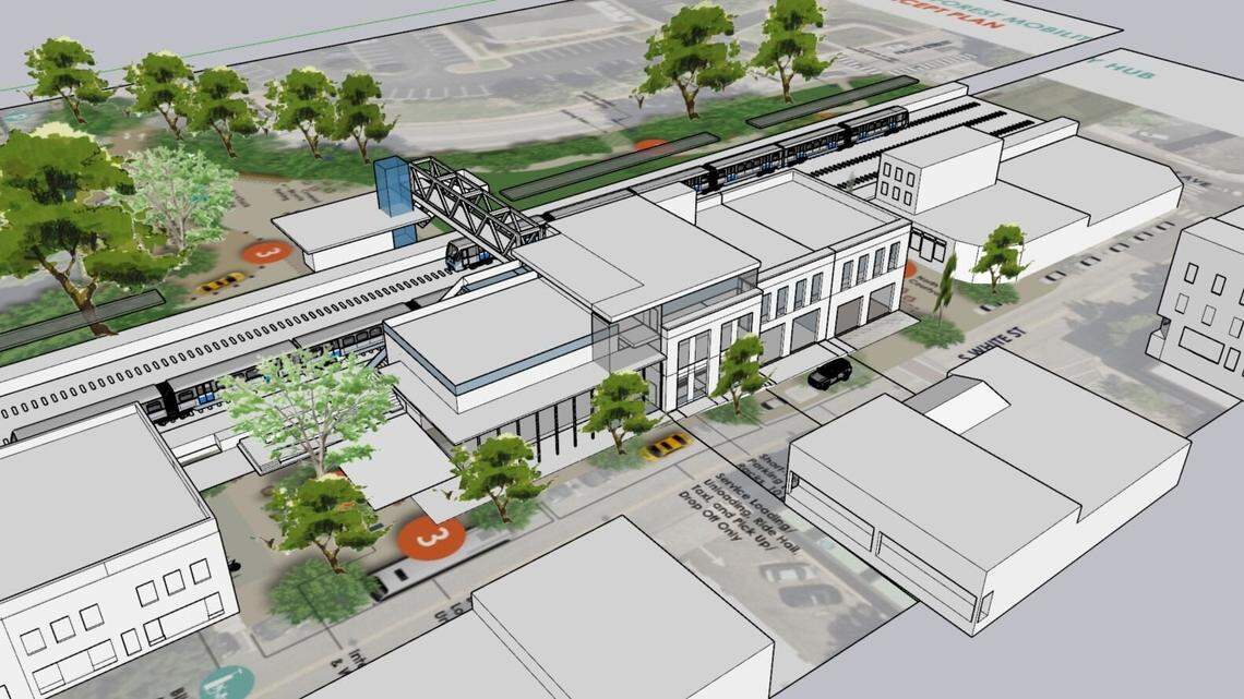 A rendering of a proposed train station in downtown Wake Forest. White Street is in the foreground, with a pedestrian bridge over the tracks to a planned drop-off and pick-up area on East South Street.