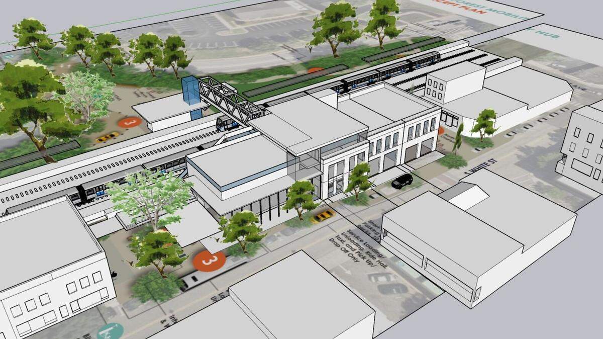 A rendering of a proposed train station in downtown Wake Forest. White Street is in the foreground, with a pedestrian bridge over the tracks to a planned drop-off and pick-up area on East South Street.