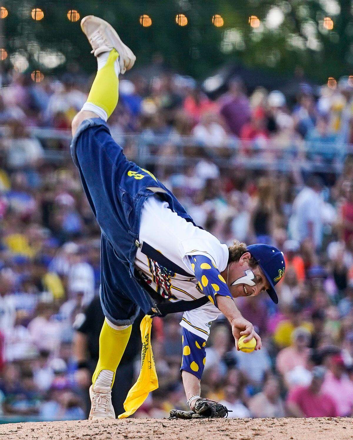 Savannah Bananas Mat Wolf (4) cartwheels before throwing the ball Friday, June 30, 2023, during the Savannah Bananas World Tour at Victory Field in Indianapolis.