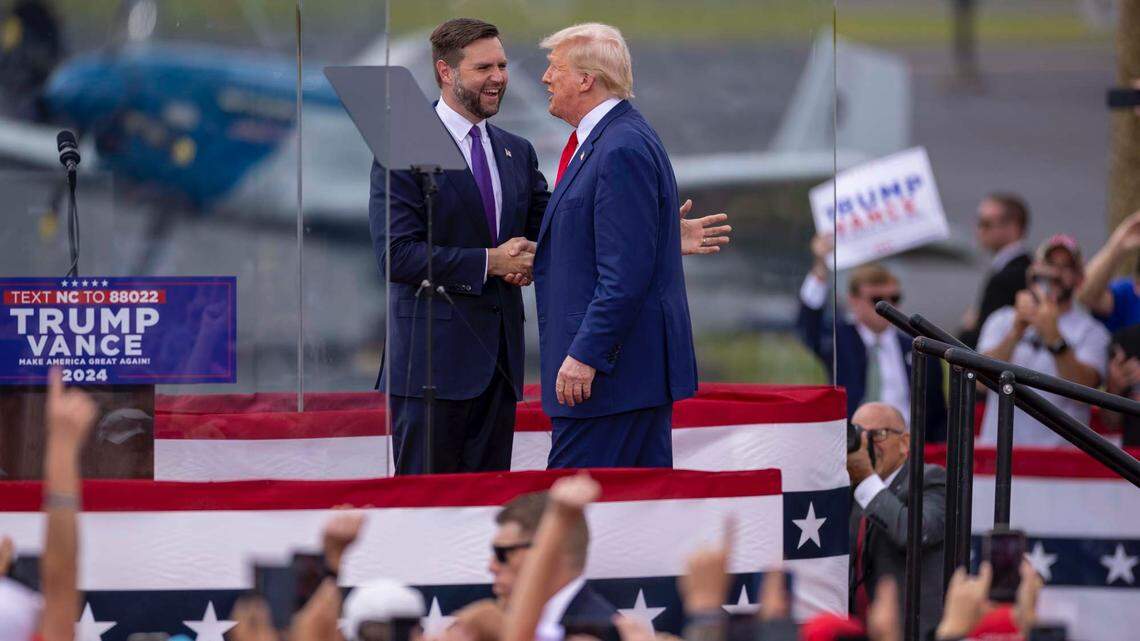 Vice presdential nominee JD Vance greets Donald Trump as Trump takes the stage at a campaign rally in Asheboro, N.C., Wednesday, August. 21, 2024.