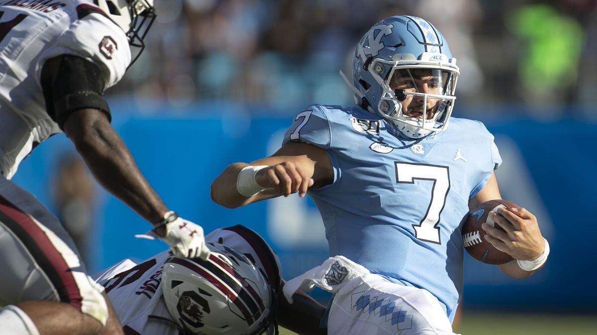 North Carolina quarterback Sam Howell (7) slides against South Carolina at Bank of America Stadium in their 2019 game.