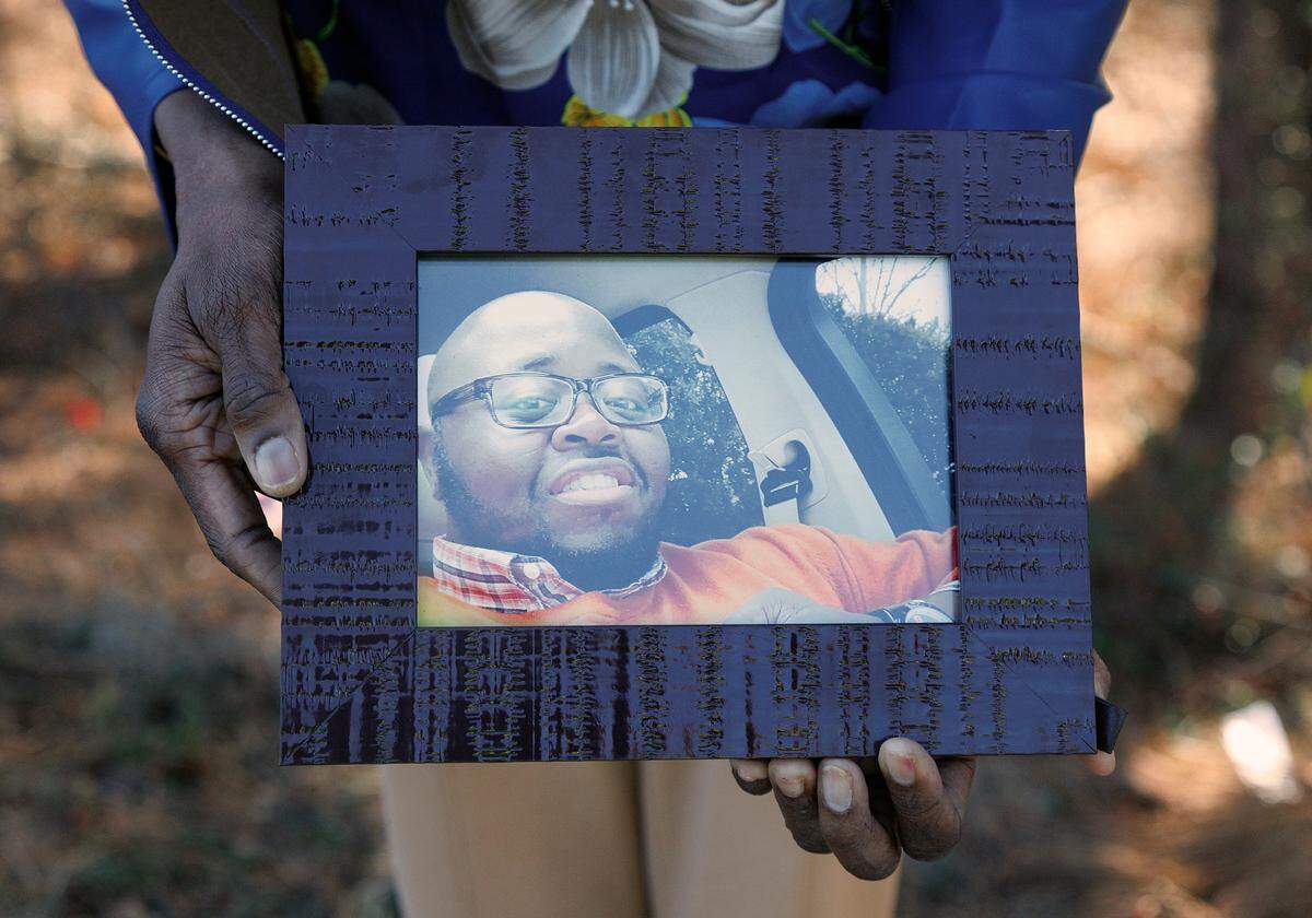 Gloria Williams, photographed on Friday, Feb. 7, 2025, holds a photograph of her son, Timothy Hall Jr., who was killed in a 2022 crash near the Interstate-40 and Interstate-540 interchange.