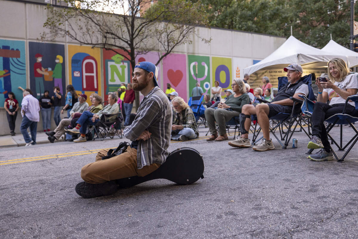Festival-goers listen as eighth-generation ballad singer Donna Ray Norton of Madison County performs during the Raleigh Wide Open music festival in downtown Raleigh on Friday, Oct. 3, 2025. The event features live bluegrass, folk, Americana and gospel artists.