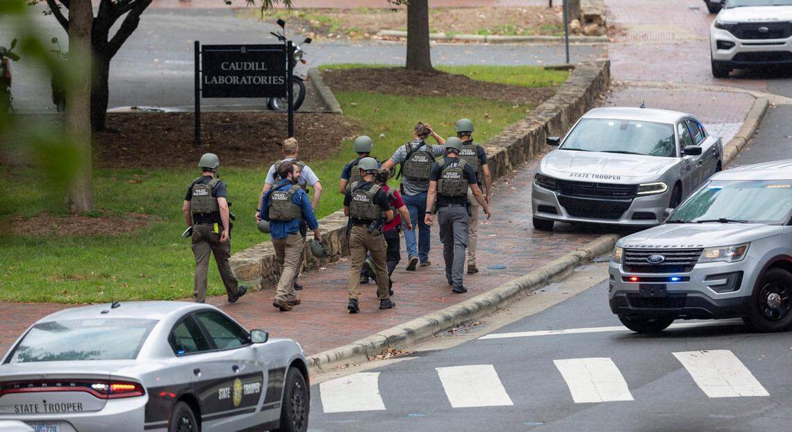 North Carolina ALE Agents exit the Caudill Laboratories building near the Bell Tower on the University of North Carolina campus after a report of an armed and dangerous person on Monday, August 28. 2023 in Chapel Hill, N.C.