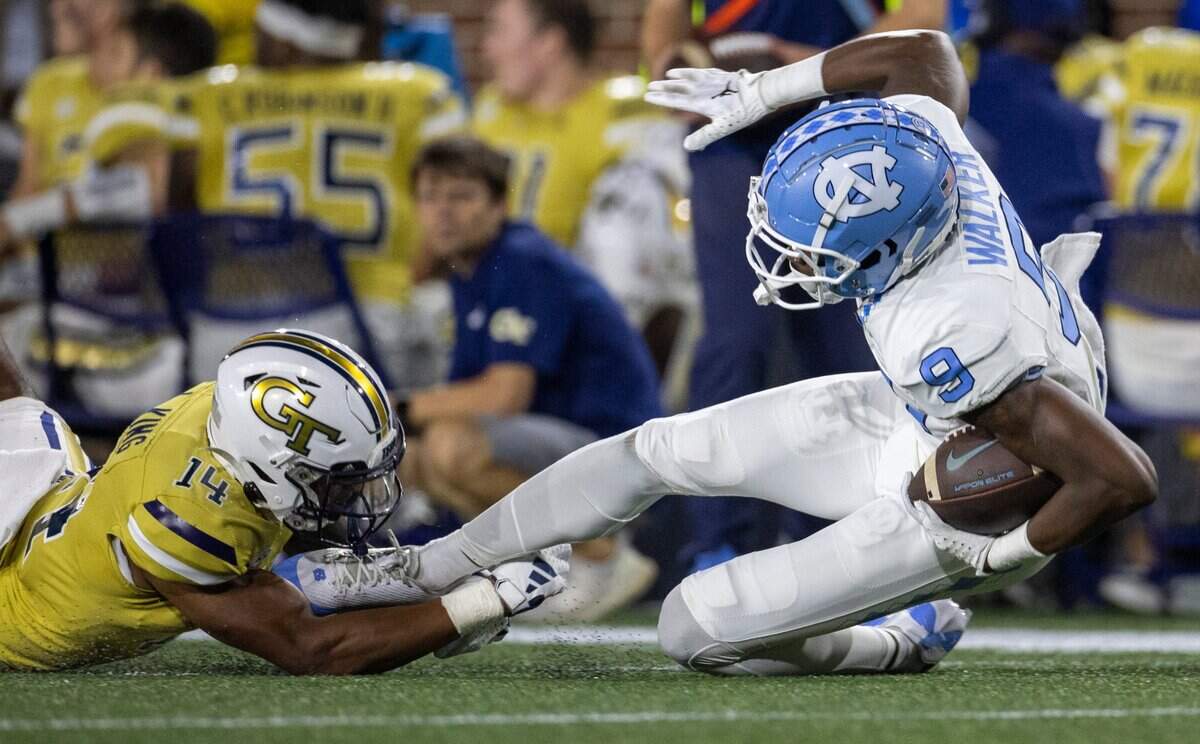 Georgia Tech’s Jaylon King (14) stops North Carolina’s Devontez Walker (9) after a pass completion from quarterback Drake Maye for an eight yard gain and a first down in the second quarter on Saturday, October 28, 2023 at Bobby Dodd Stadium in Atlanta, Georgia.
