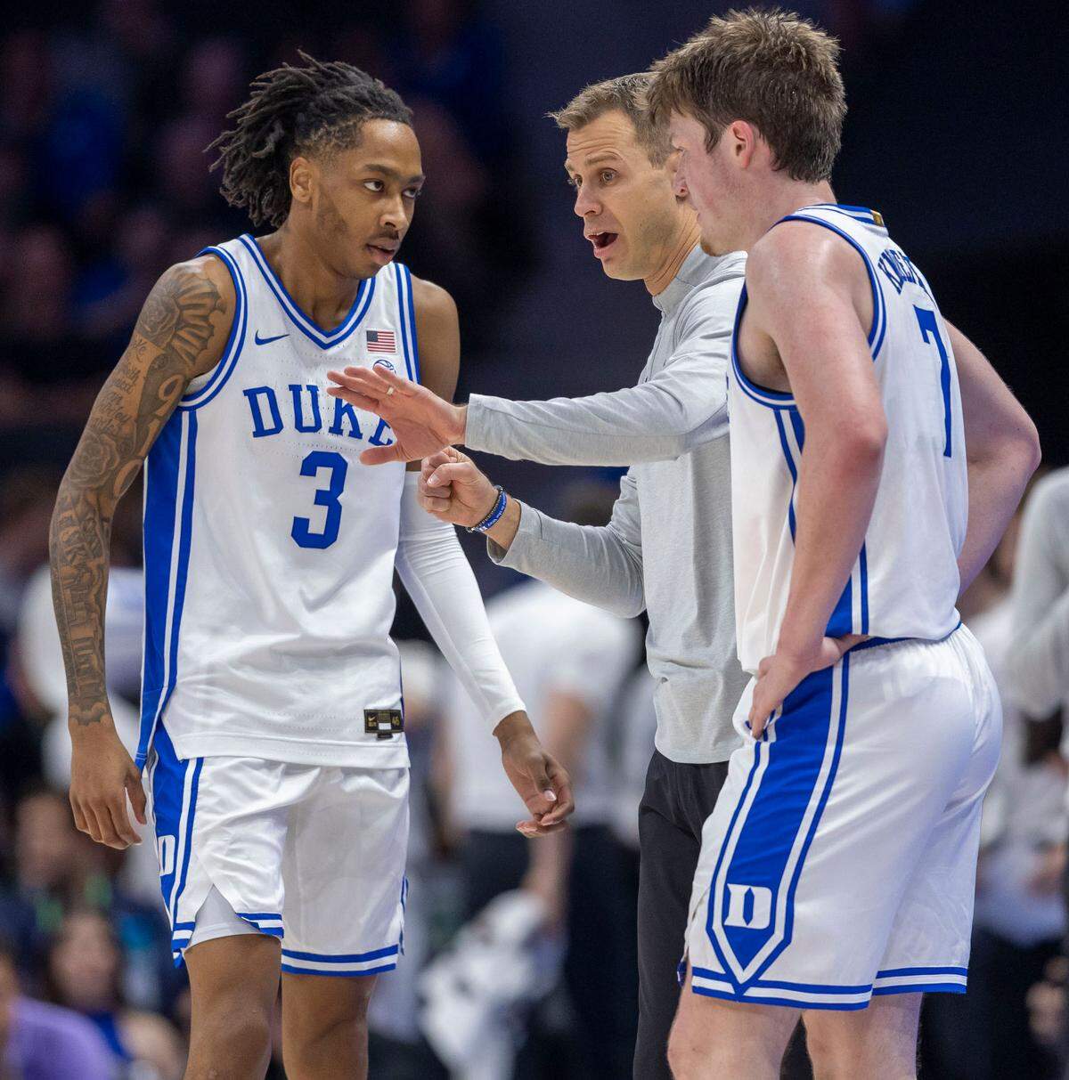 Duke’s coach Jon Scheyer talks with Isaiah Evans (3) and Kon Knueppel (7) in the first half against Georgia Tech on Thursday, March 13, 2025 during the quarterfinals of the ACC Tournament at Spectrum Center in Charlotte, N.C.