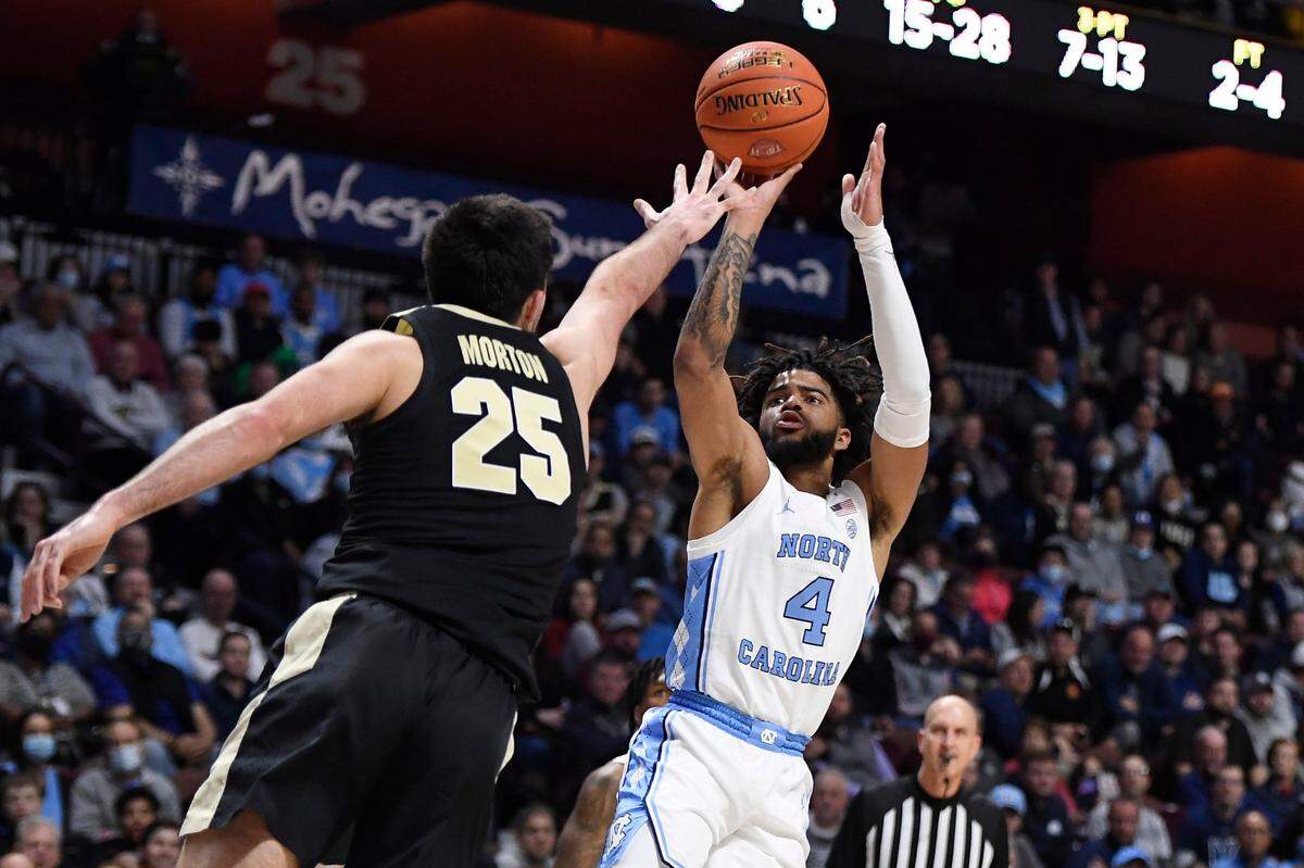 North Carolina’s R.J. Davis (4) shoots over Purdue’s Ethan Morton (25) in the first half of an NCAA college basketball game, Saturday, Nov. 20, 2021.