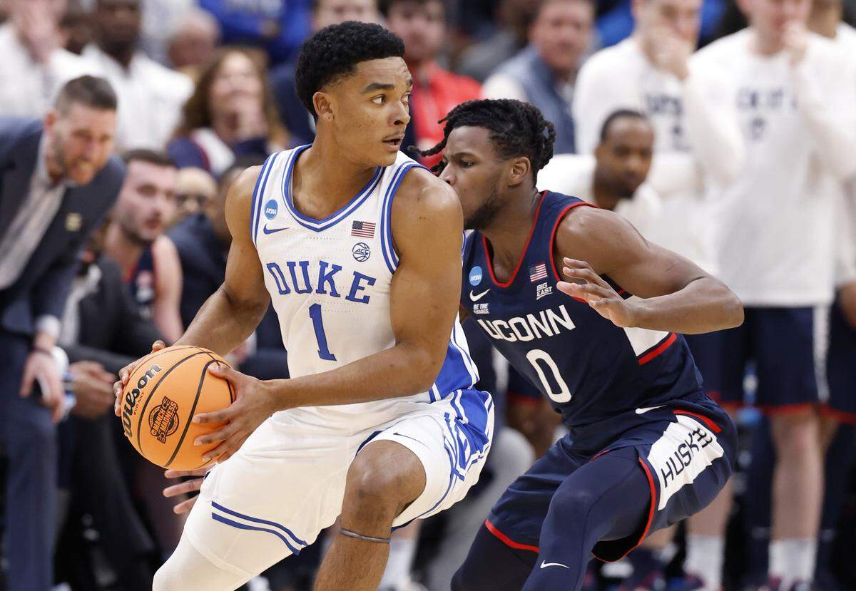 Duke’s Caleb Foster (1) works around UConn's Malachi Smith (0) during the first half of Duke’s game against Connecticut in the NCAA Men’s Tournament East Regional Final at Capital One Arena in Washington, D.C., Sunday, March 29, 2026.