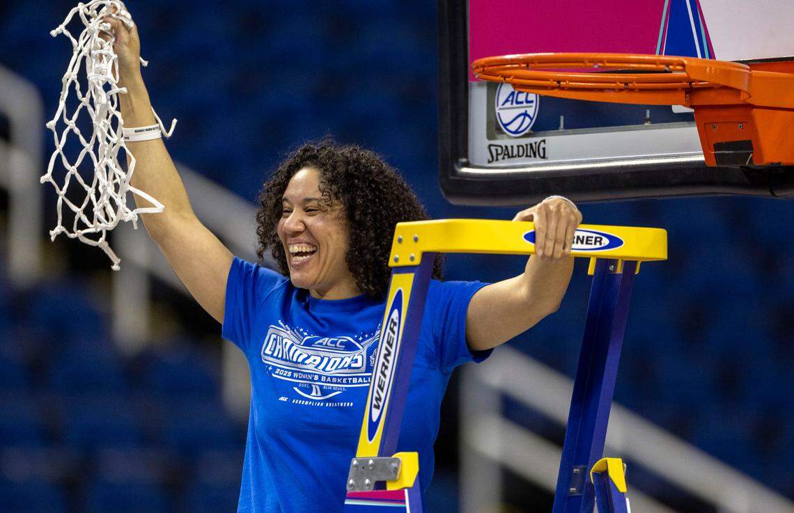 Duke coach Kara Lawson celebrates after cutting down the net following the Blue Devils 76-62 victory over N.C. State to clinch the ACC Championship on Sunday, March 9, 2025 in Greensboro, N.C.