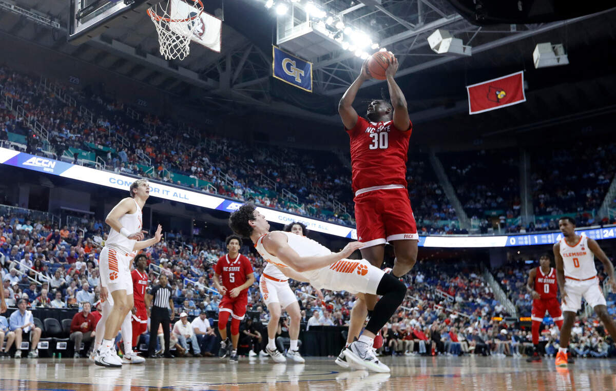 N.C. State’s D.J. Burns Jr. (30) shoots as Clemson’s PJ Hall (24) defends during Clemson’s 80-54 victory over N.C. State in the quarterfinals of the ACC Men’s Basketball Tournament in Greensboro, N.C., Thursday, March 9, 2023.