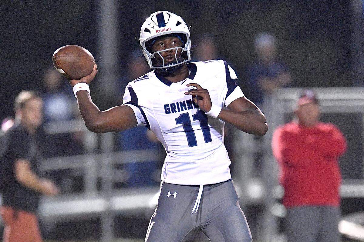 Grimsley quarterback Faizon Brandon (11) looks to pass against Rolesville during the first half. The Rolesville Rams and the Greensboro Grimsley Whirlies met in a non-conference football game in Rolesville, N.C. on August 30, 2024.