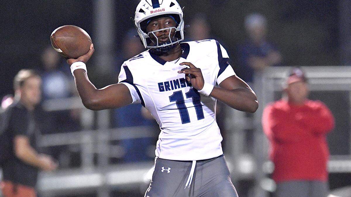 Grimsley quarterback Faizon Brandon (11) looks to pass against Rolesville during the first half. The Rolesville Rams and the Greensboro Grimsley Whirlies met in a non-conference football game in Rolesville, N.C. on August 30, 2024. 