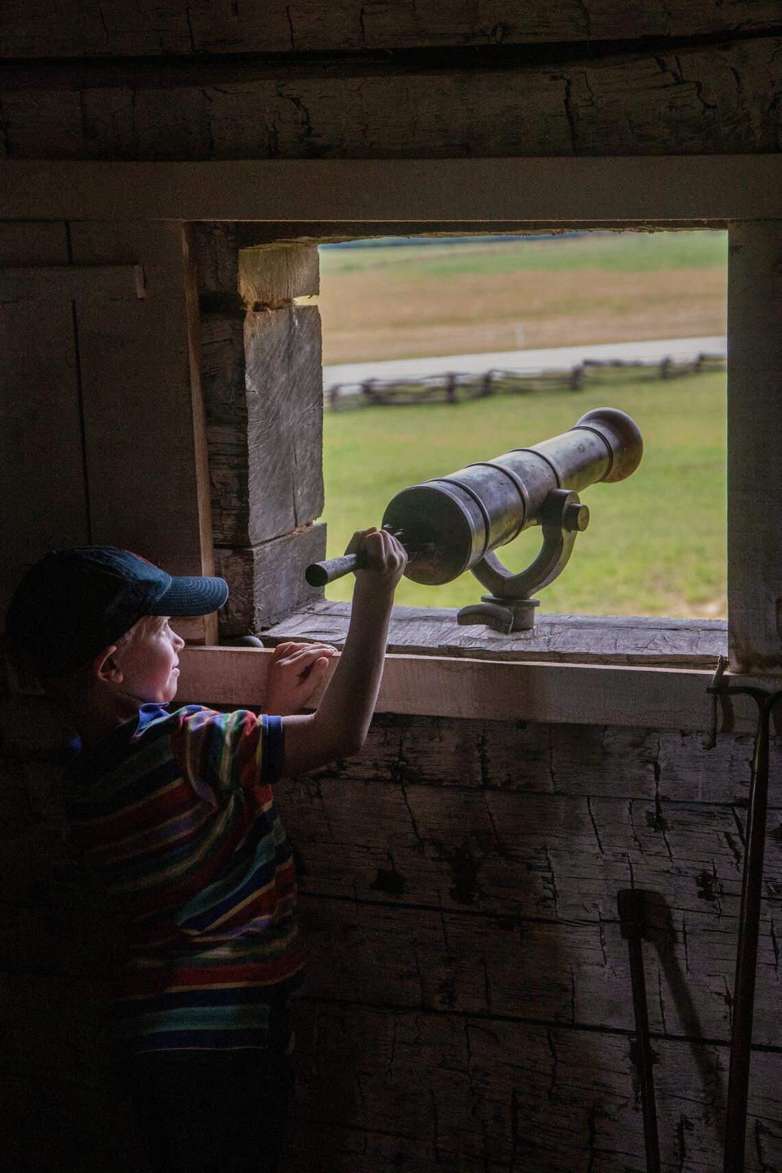 Alex Shore, 7, of Raleigh points a cannon from the second floor of Fort Dobbs near Statesville. The historic site is a recreation of a fort built in 1755 when North Carolina was still a colony.