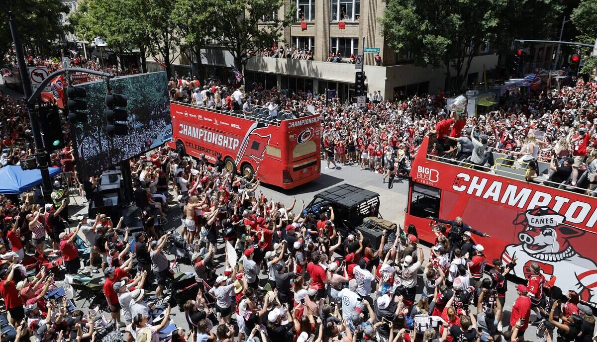 Carolina's Jaccob Slavin and Sebastian Aho raise the Cup as the ride down Fayetteville St. during a parade and rally for the Carolina Hurricanes in downtown Raleigh Saturday, June 20, 2026.